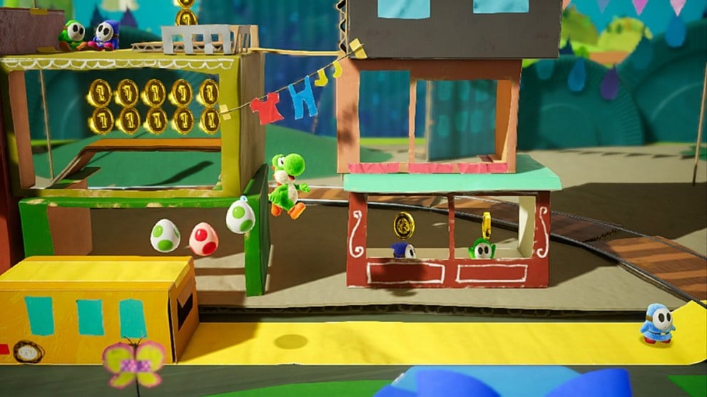 Yoshi, Nintendo's green dinosaur character, jumps from a cardboard platform - followed by a trail of spotted eggs. The world itself is crafted from paper, and appears to be in the shape of a shop stall run by Shy Guys.